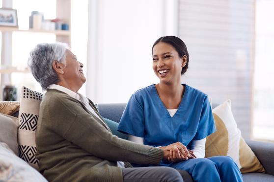Nurse talking to patient about health screenings they can get during in-home health assessment