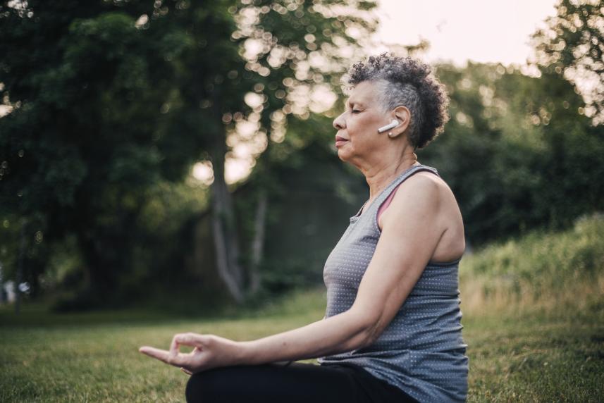 Woman sitting outdoors meditating