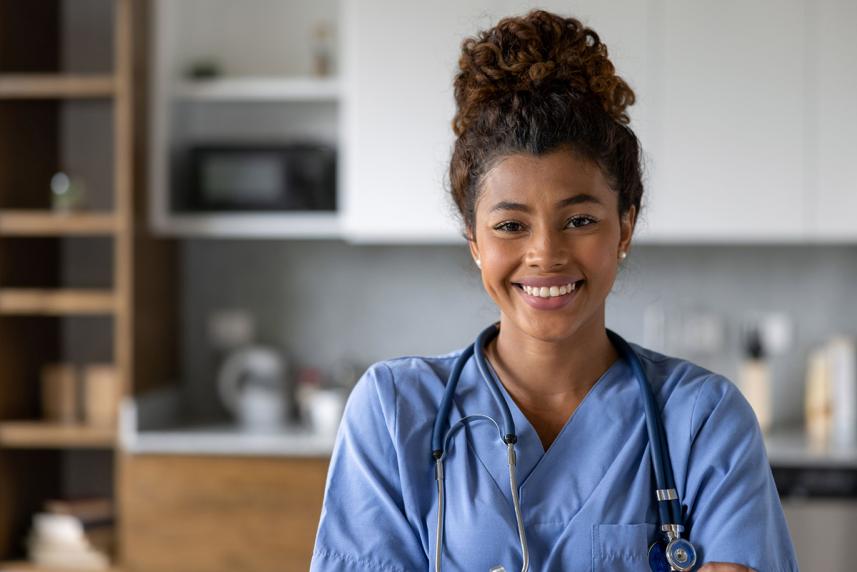 Healthcare worker in office smiling at the camera
