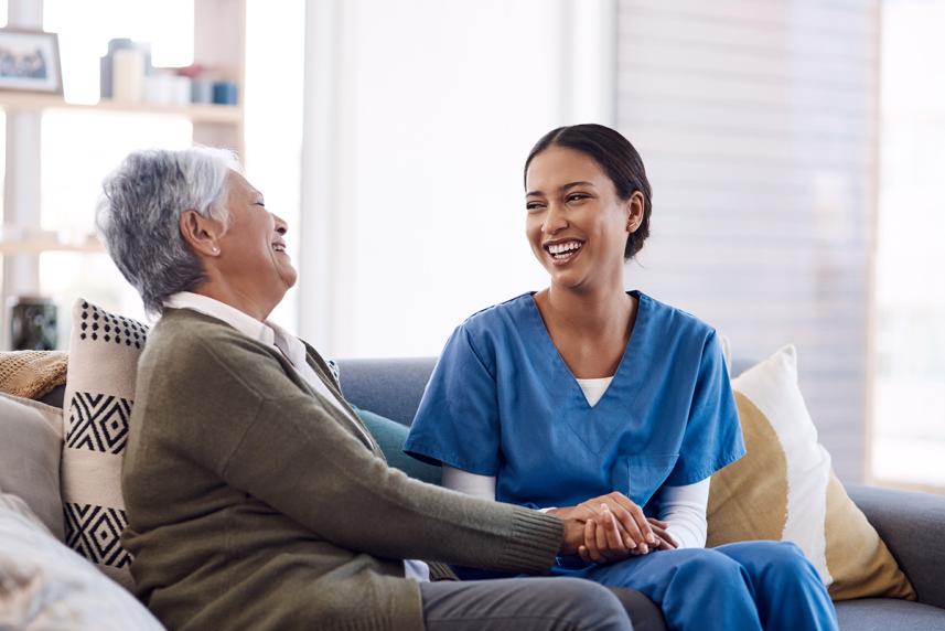 Nurse talking to patient about health screenings they can get during in-home health assessment